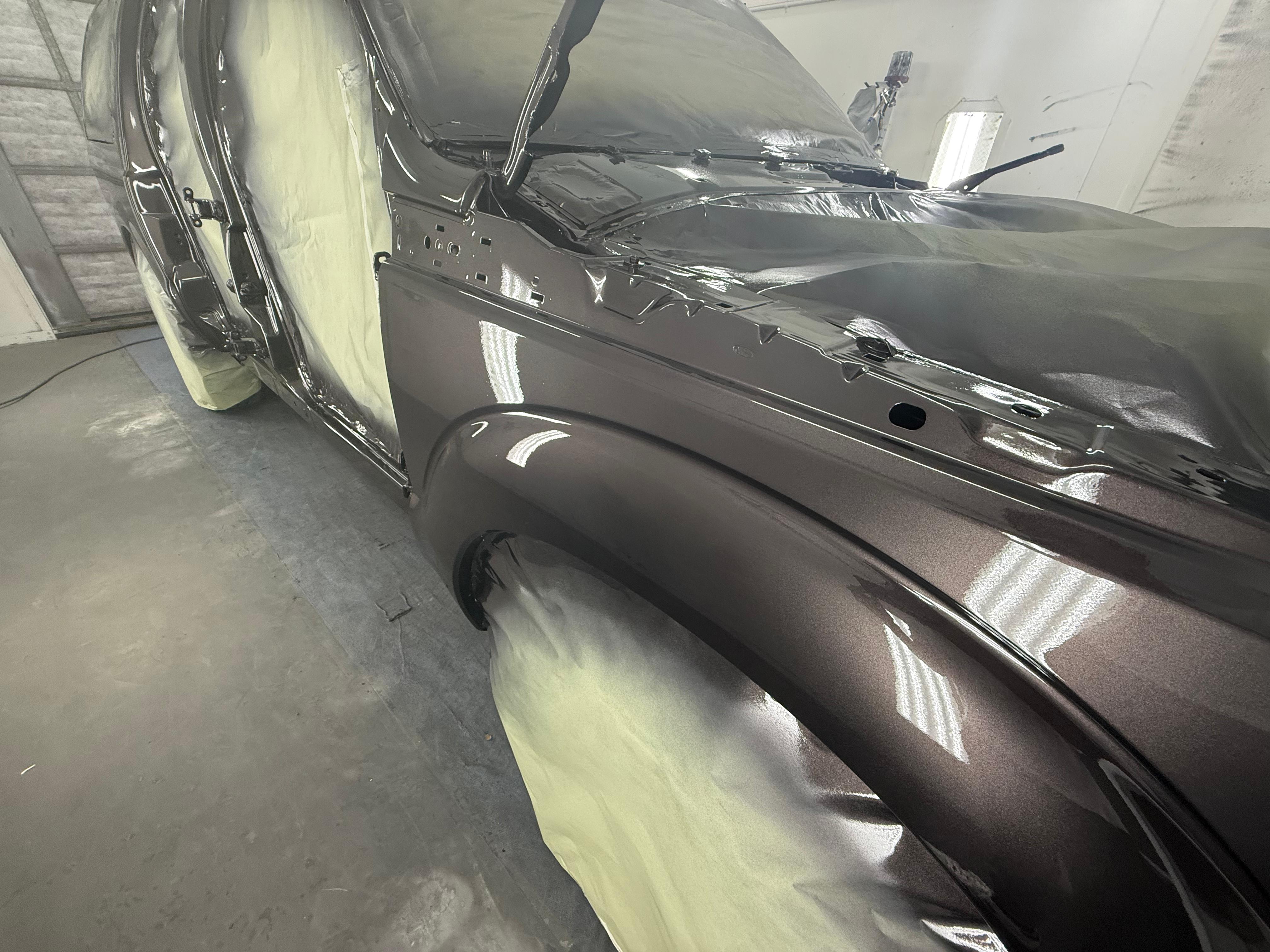 Glossy dark metallic fender close-up